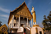 Vientiane, Laos - Pha That Luang, the elegant structure, Wat That Luang Neua, with a very ornate front faade fronted by two tall standing Buddha statues. 